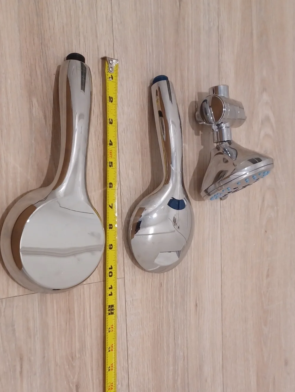 Bundle of chrome shower heads with flexible hose. Bath. Hand held.